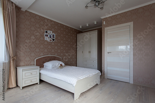 Interior of a bedroom in light brown tones for little girl