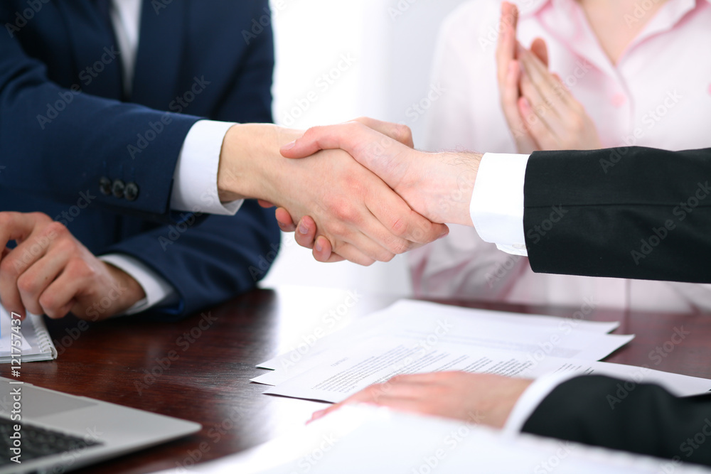 Business people shaking hands finishing up a meeting Business people shaking hands finishing up a meeting