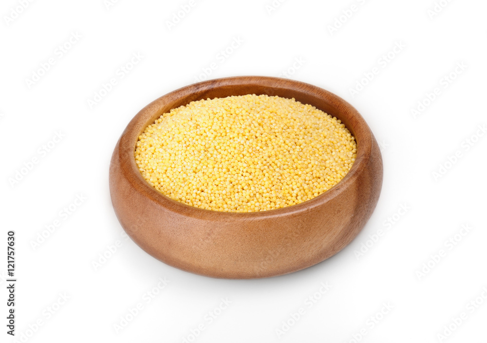 millet groats in a wooden bowl on a white background. ingredient for a healthy lifestyle. millet groats in a wooden bowl on a white background. ingredient for a healthy lifestyle.