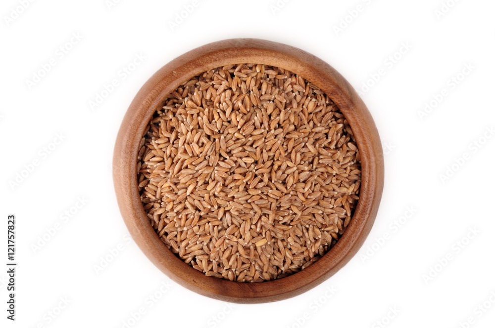 cereal spelled in wooden bowl on a white background. ingredient for a healthy lifestyle. cereal spelled in wooden bowl on a white background. ingredient for a healthy lifestyle.
