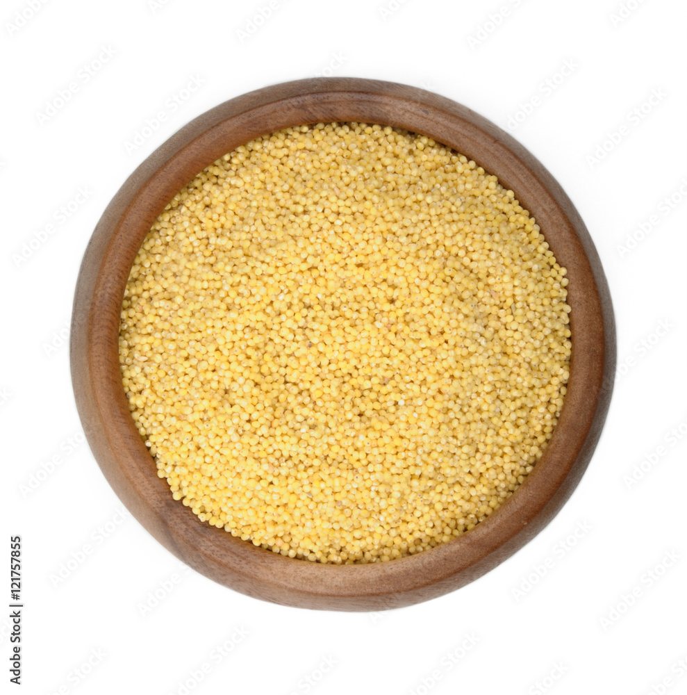 millet groats in a wooden bowl on a white background. ingredient for a healthy lifestyle. 