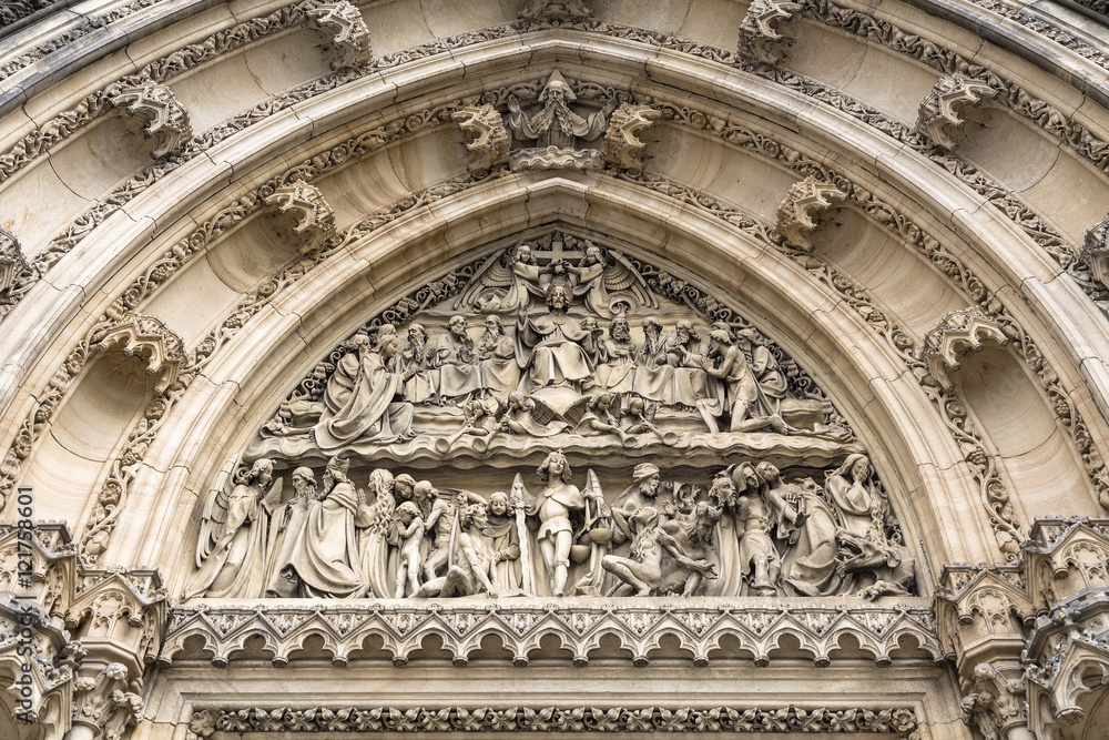 Obraz premium Bas-relief carved in stone above the entrance to the Catholic Ca