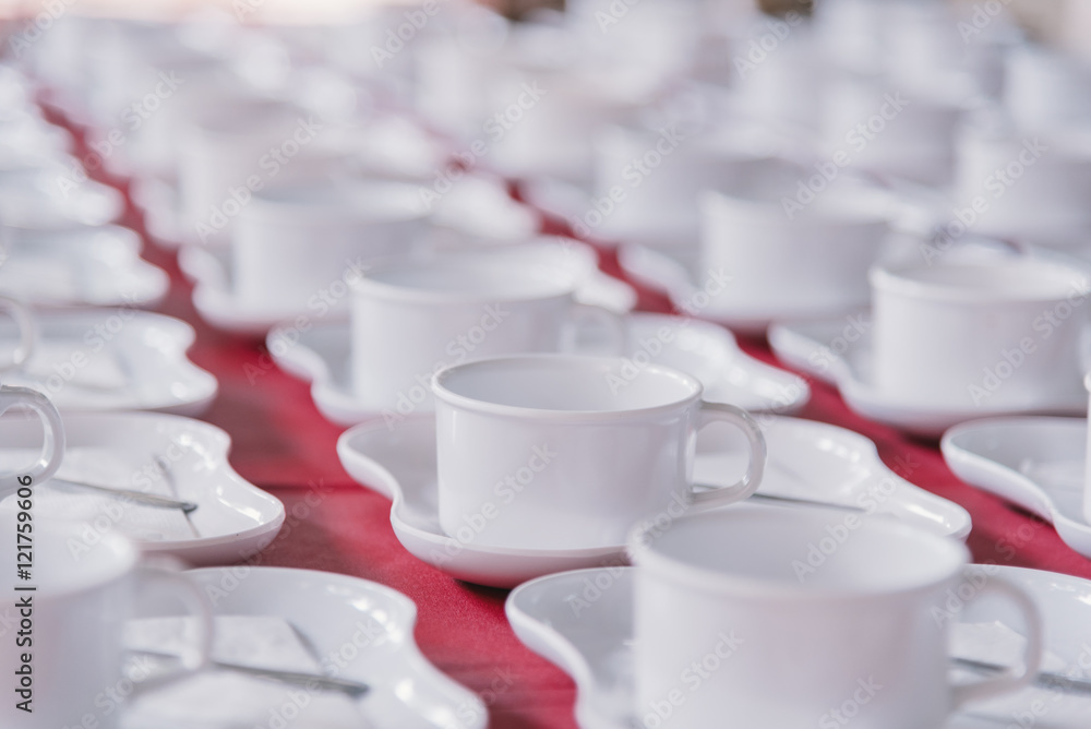 Many rows of white ceramic coffee or tea cups. Many rows of white ceramic coffee or tea cups.