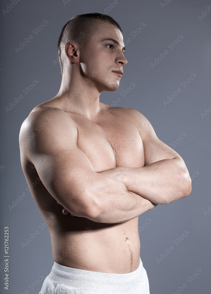 strong brutal short-hair man bodybuilder with muscular isolated on gray  background Stock Photo | Adobe Stock