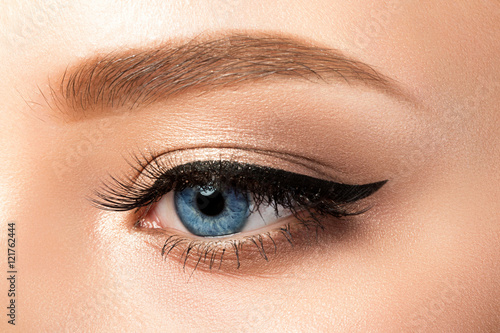 Close up view of blue woman eye with beautiful makeup photo