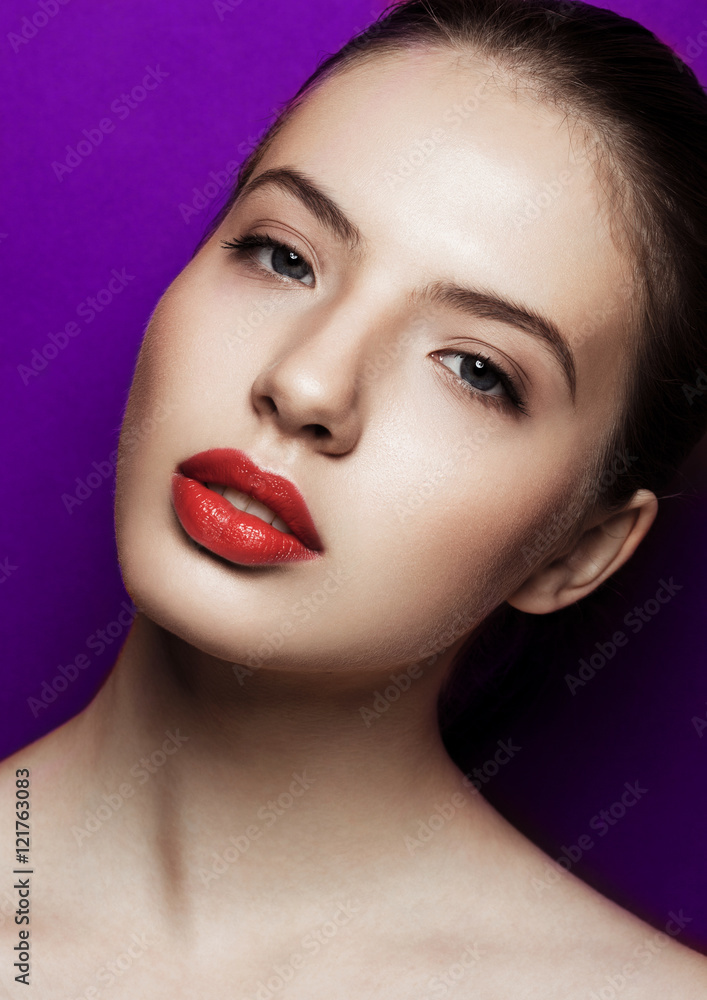 Beautiful woman with makeup red lips on purple background Beautiful woman with makeup red lips on purple background