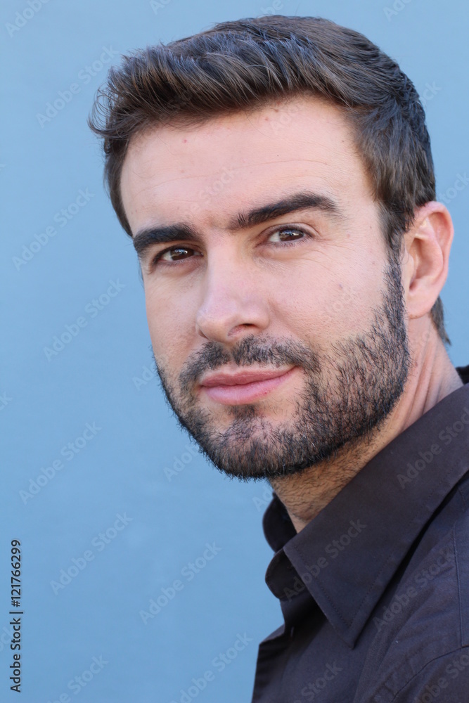 Fototapeta premium Portrait of attractive businessman on blue background / Closeup of young interesting businessman