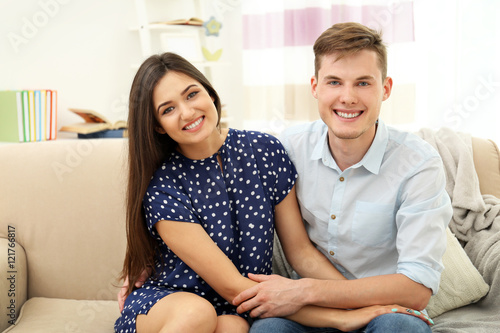 Beautiful young couple sitt...