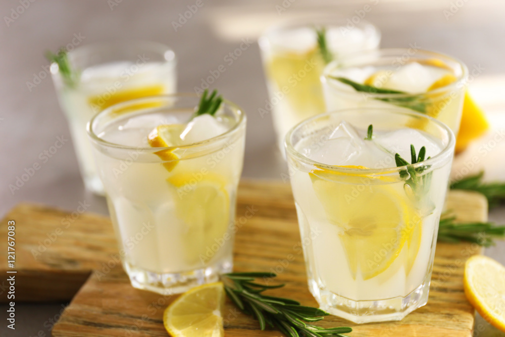 Cold fresh cocktails with lemon on cutting board Cold fresh cocktails with lemon on cutting board