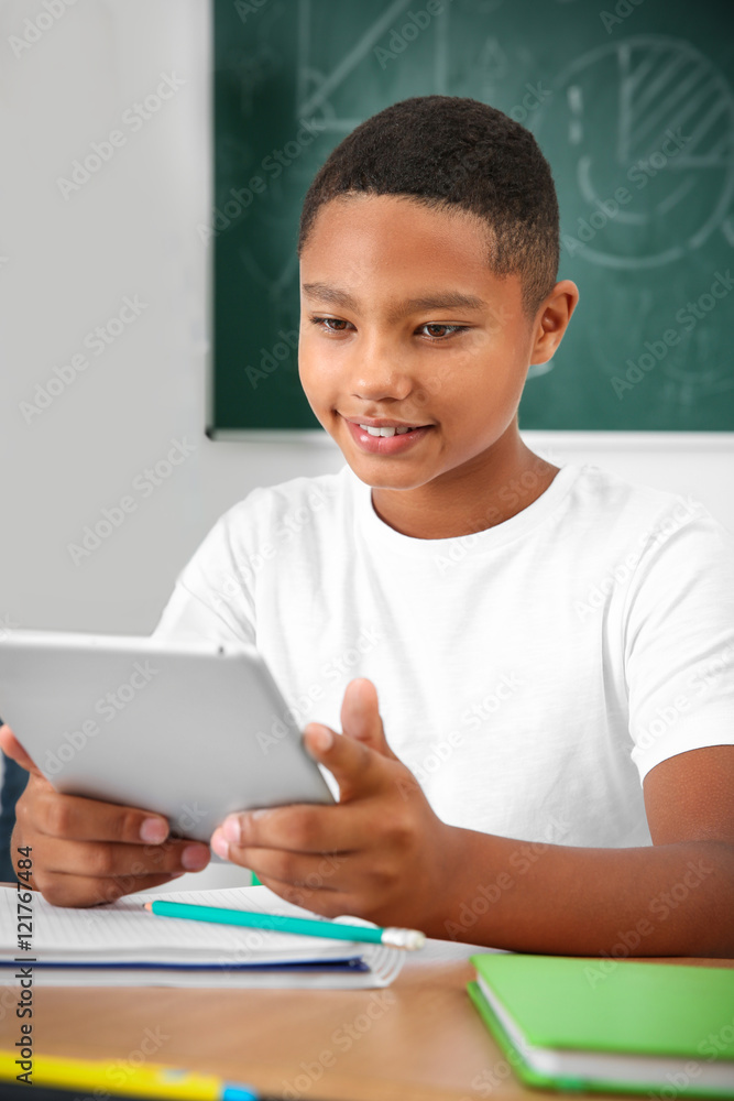Pupil with tablet computer sitting in classroom Pupil with tablet computer sitting in classroom