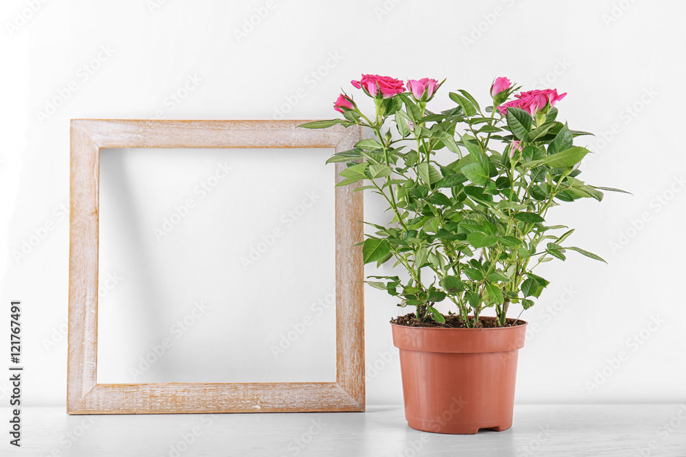 Vase with roses and photo frame on table Vase with roses and photo frame on table