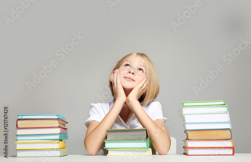 Cute girl with books on gre...
