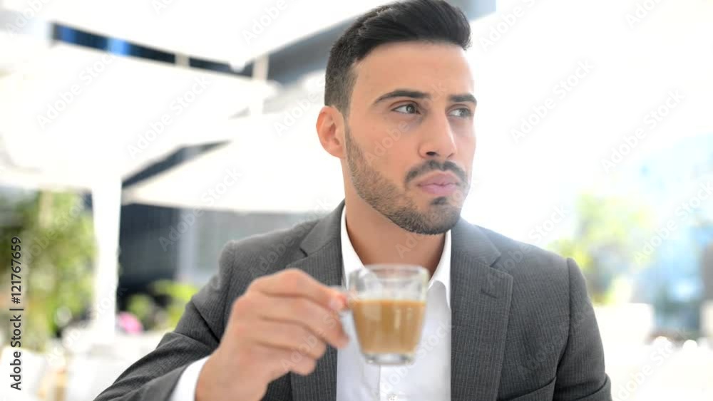 Young businessman drinking coffee outdoor Young businessman drinking coffee outdoor