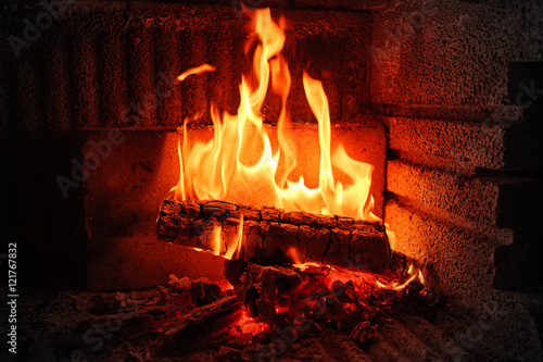 Burning wood in brick fireplace