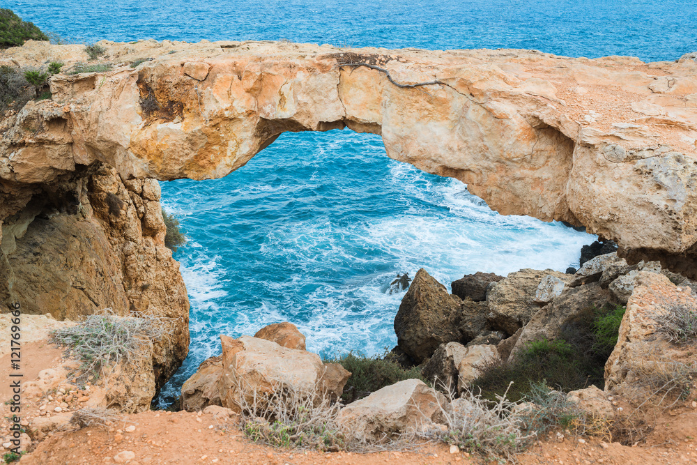Natural Rock Bridge at Cape Greco near Ayia Napa in the evening light. Cyprus