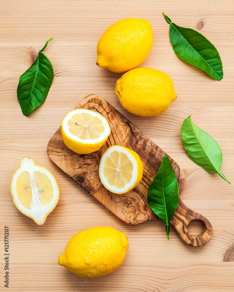 Fresh lemons and lemons leaves on rustic wooden background. Fre Fresh lemons and lemons leaves on rustic wooden background. Fre