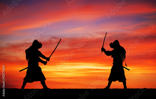 Silhouette of samurais in duel. Picture with two samurais and su