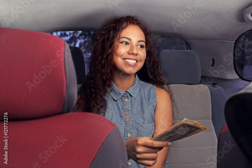 Beautiful girl paying for taxi