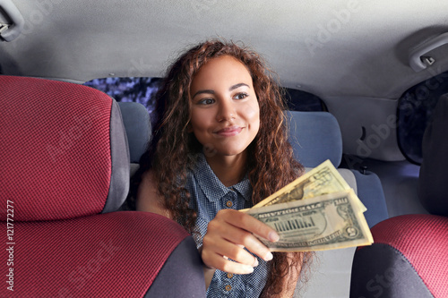 Beautiful girl paying for taxi
