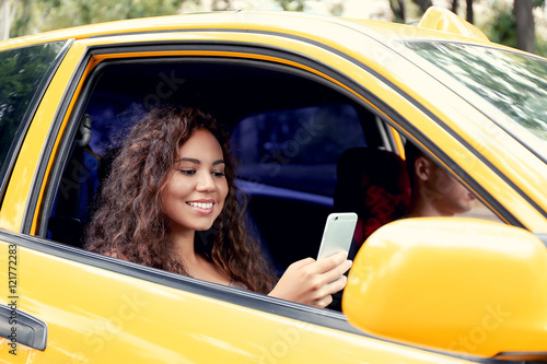 Beautiful girl in taxi car
