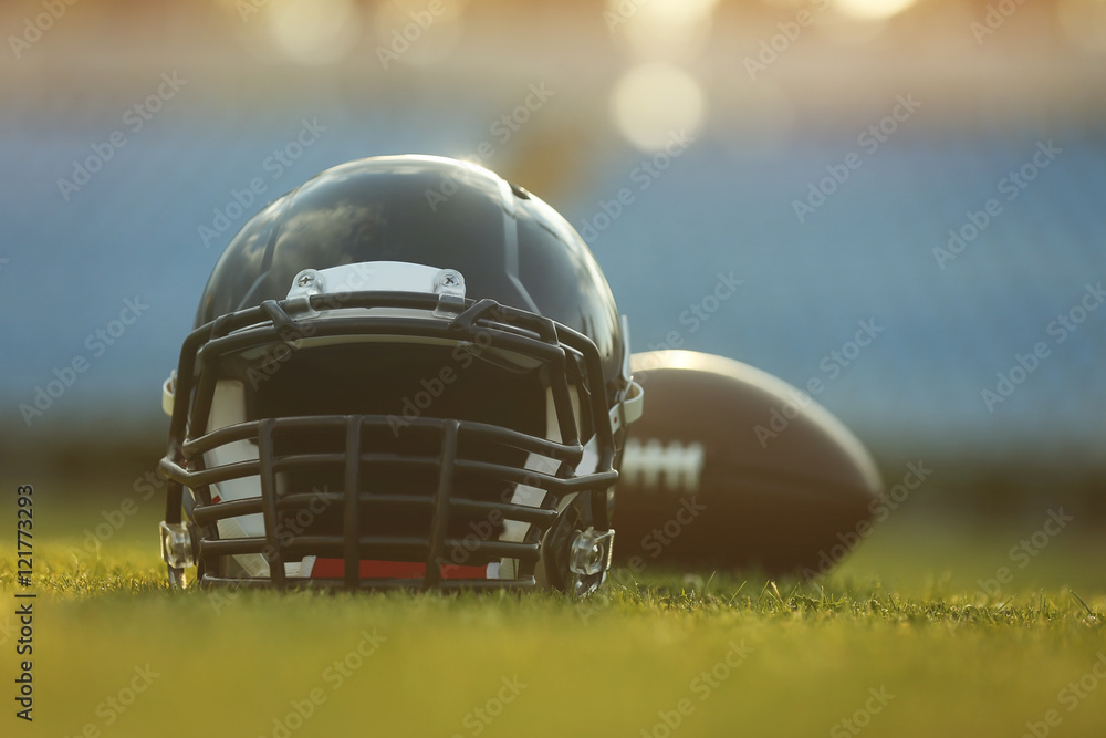 Rugby helmet with ball on field Rugby helmet with ball on field