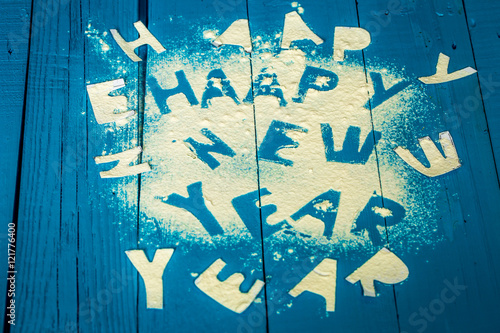 text happy new year on the blue wood background