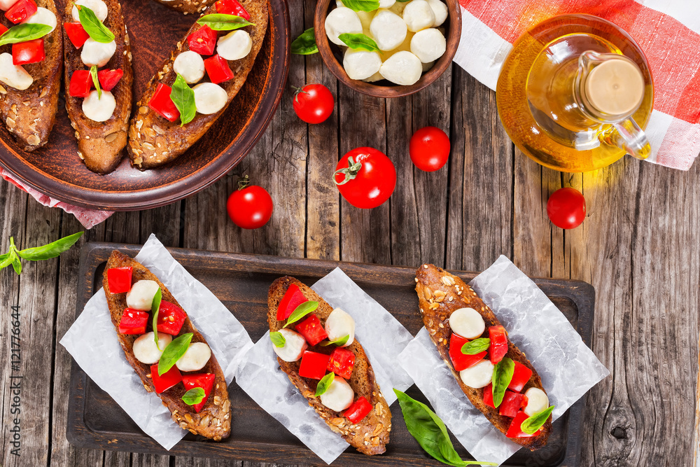 bruschetta  with caprese salad on rye baguette, close-up