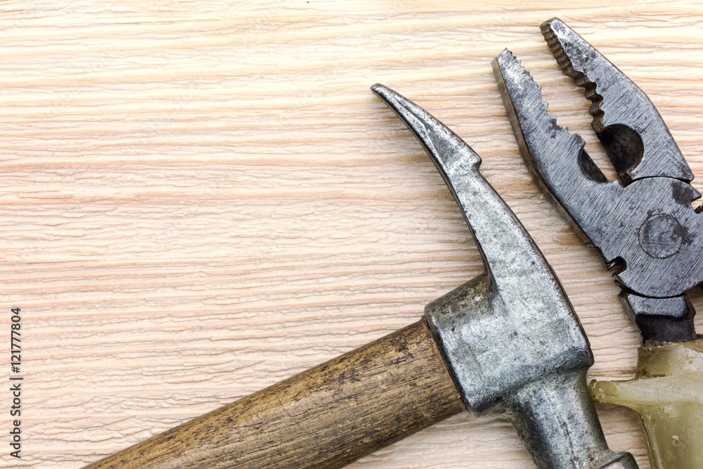 old grungy hammer and pliers as instruments for house renovation old grungy hammer and pliers as instruments for house renovation