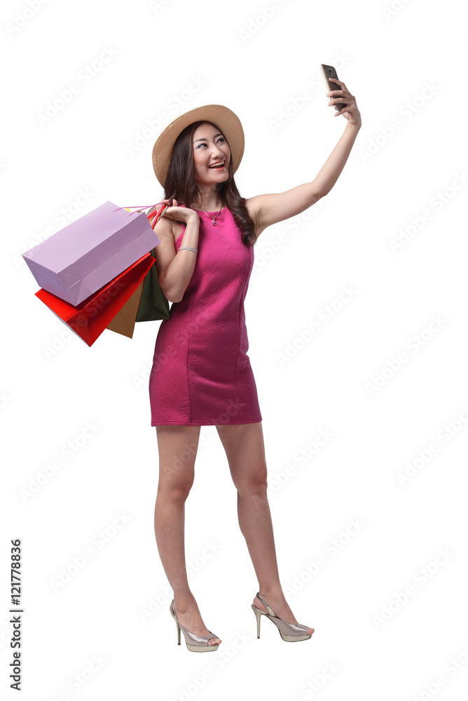 Beautiful asian girl holding shopping bags and taking selfie with cellphone Beautiful asian girl holding shopping bags and taking selfie with cellphone