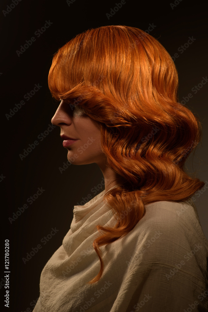 Portrait of beautiful young red haired woman with fashion makeup and hairstyle posing in the studio Portrait of beautiful young red haired woman with fashion makeup and hairstyle posing in the studio