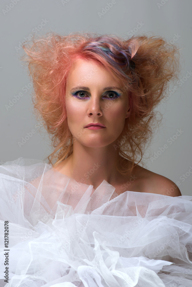 Portrait of a beautiful woman with multi coloured strand in hair, professional hair colouring