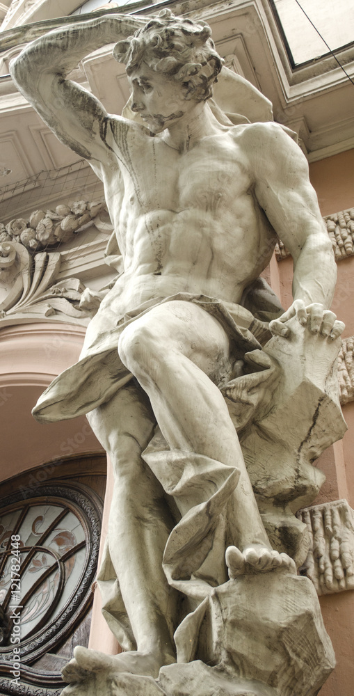 Obraz premium male figure sculpture on the facade of an old house in Art Nouveau style 