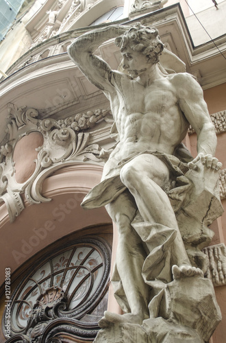 Canvas-taulu male figure sculpture on the facade of an old house in Art Nouveau style