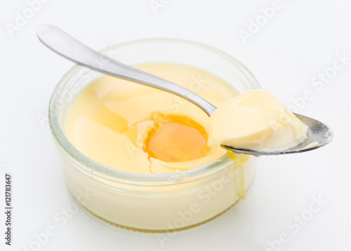 Photo Spoon takes a piece of homemade custard, isolated