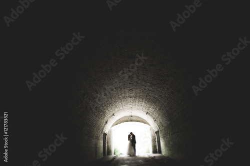 Happy newlyweds near the ancient castle on the walk