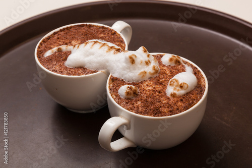 Coffee with foam in the form of cat and mouse