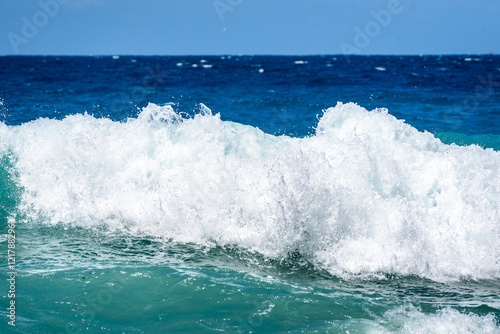 Strong winds and waves are hitting a beach or coast.