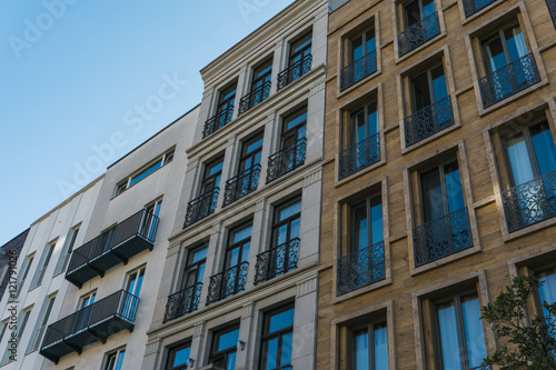 townhouses in a low angle view with orange, grey and white facade