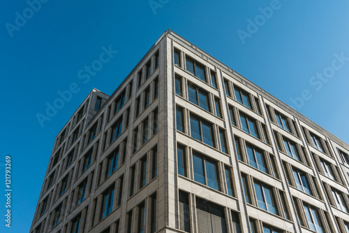 modern and big office building with marmor facade and big blue glass windows
