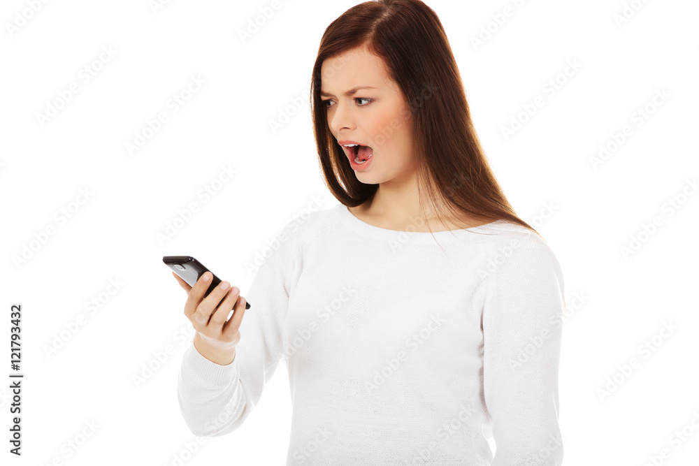 Young student woman yelling to the mobile phone Young student woman yelling to the mobile phone
