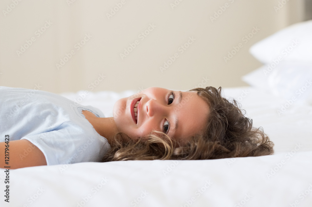 Fototapeta premium Girl lying on bed