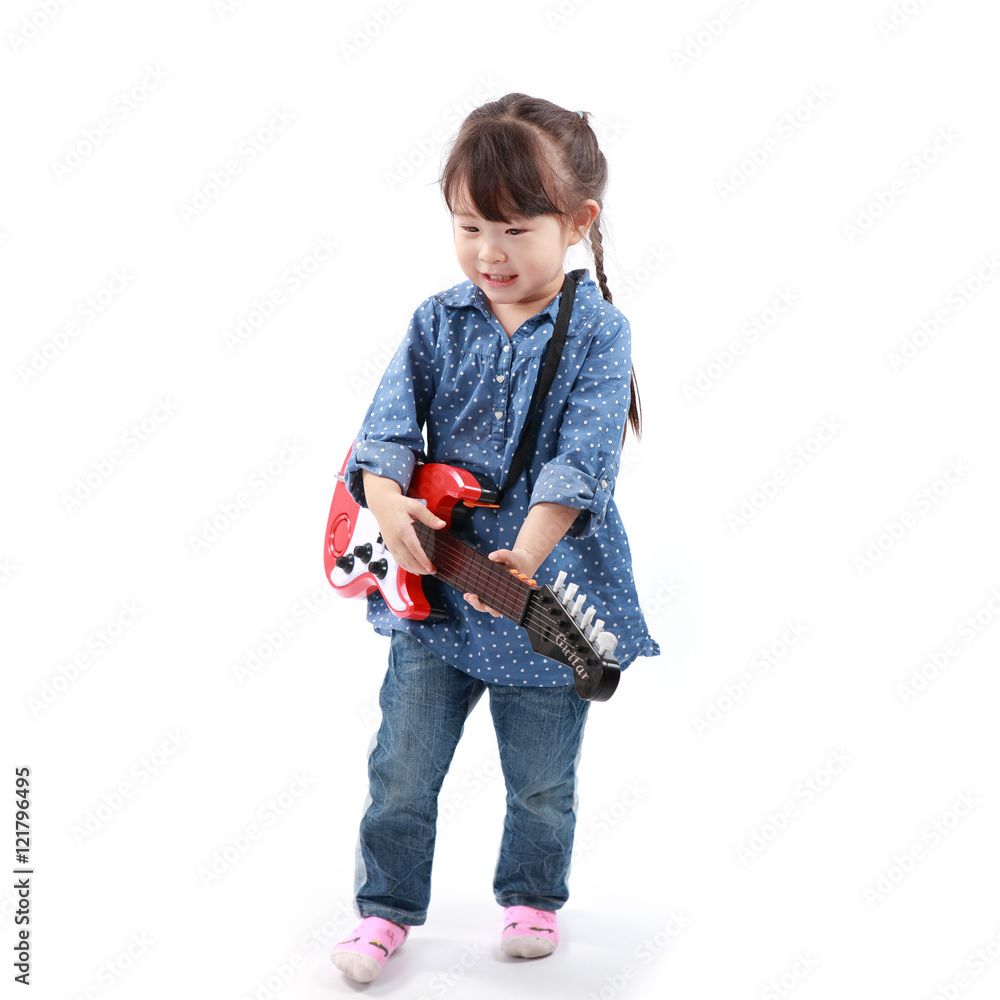 Little asian girl plays with a toy guitar on a white background Little asian girl plays with a toy guitar on a white background