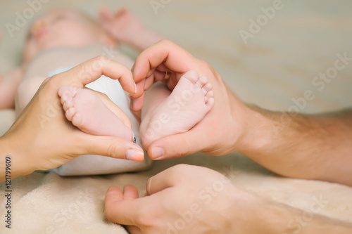 Newborn feet in parent hands