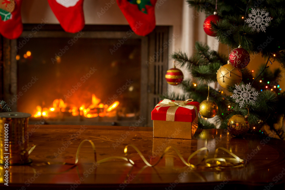 Christmas background with gift box on wooden table in front of b