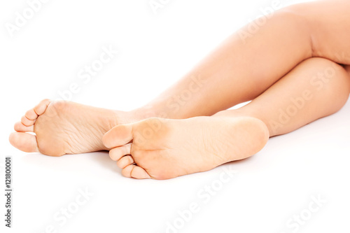 Beautiful female feet and a heel on white background.