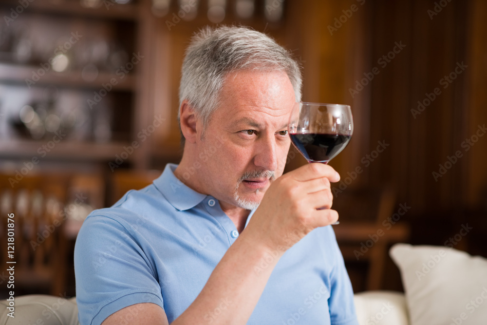Mature man enjoying a glass of red wine Mature man enjoying a glass of red wine