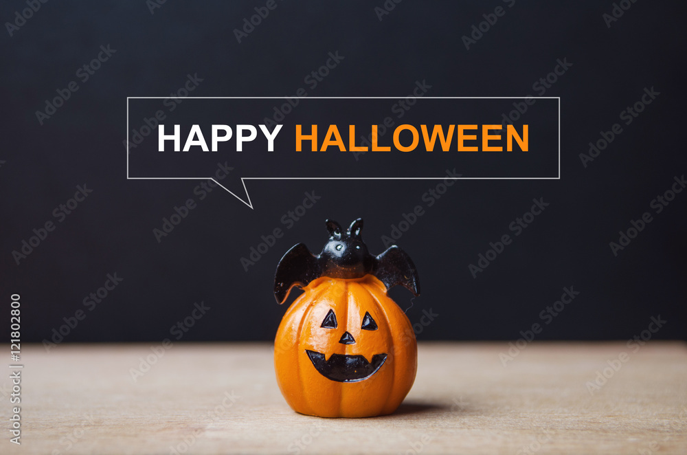 Fototapeta premium Happy Halloween message, Pumpkin on table wood with dark wall background, halloween concept.