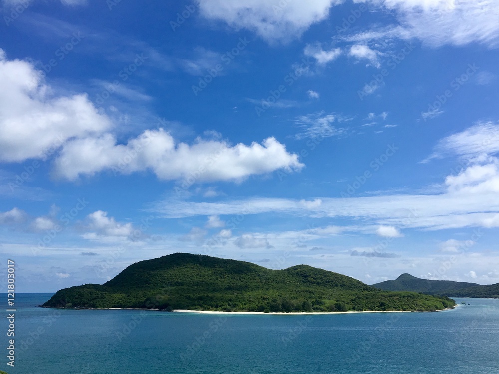 Green island under blue sky in sunny day