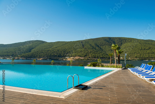 Nice swimming pool outdoors on bright summer day © Elnur