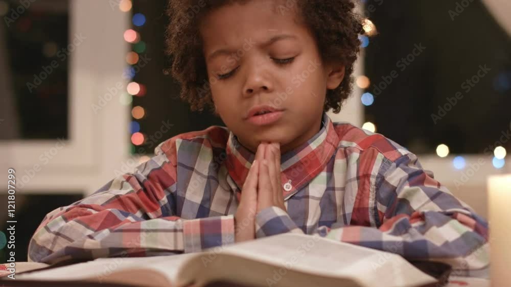 Kid is praying. Boy with closed eyes. Belief and morality. Purity of the soul. Kid is praying. Boy with closed eyes. Belief and morality. Purity of the soul.